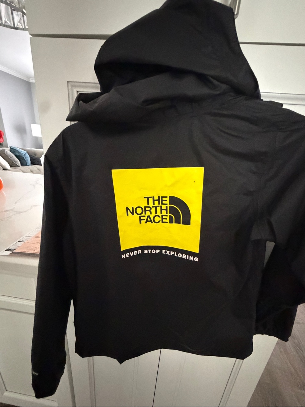 The North Face Black Raincoat with Yellow Logo Square